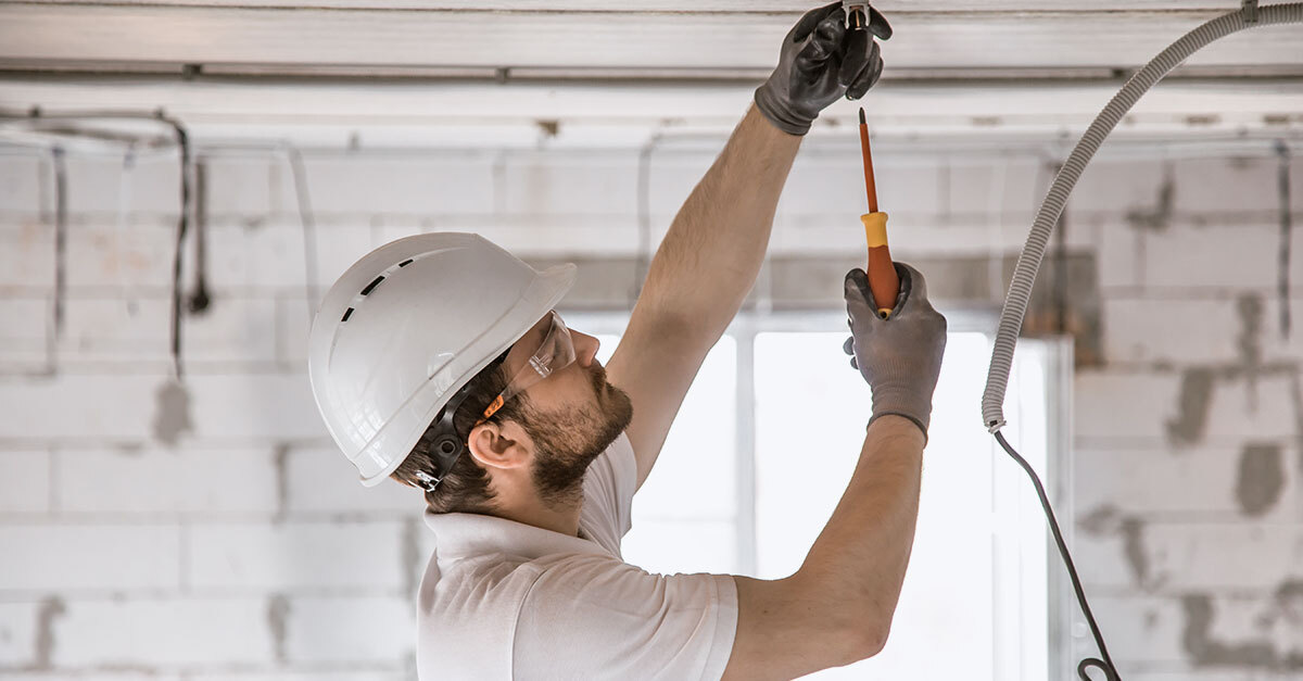 Electrical subcontractor working overhead
